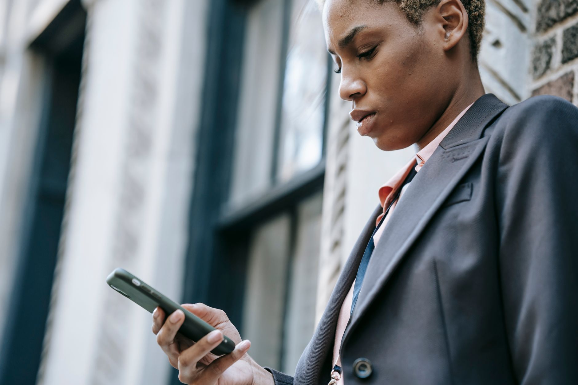 entrepreneur filling out online form on smartphone with focused expression