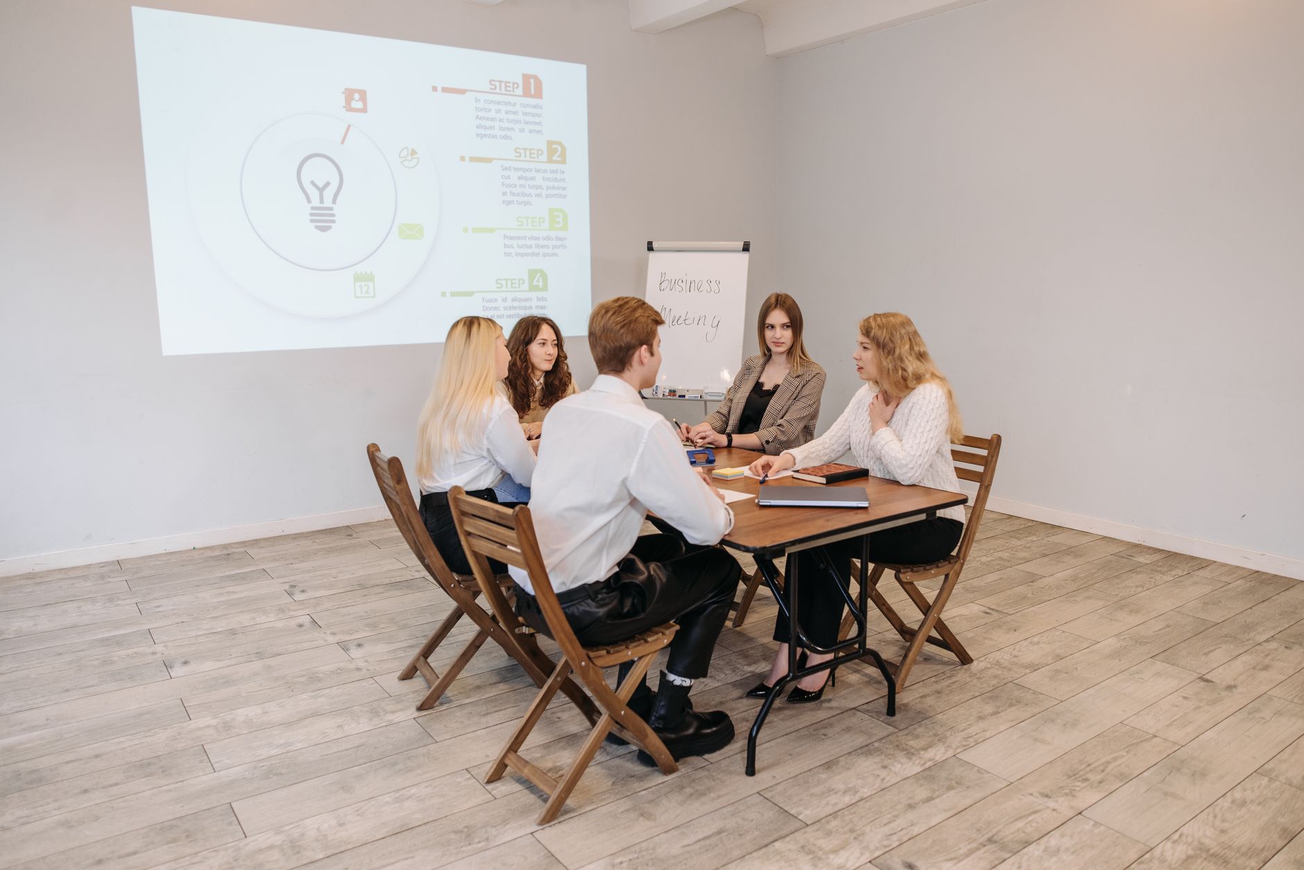 entrepreneur presenting online business offer to small group in modern workspace